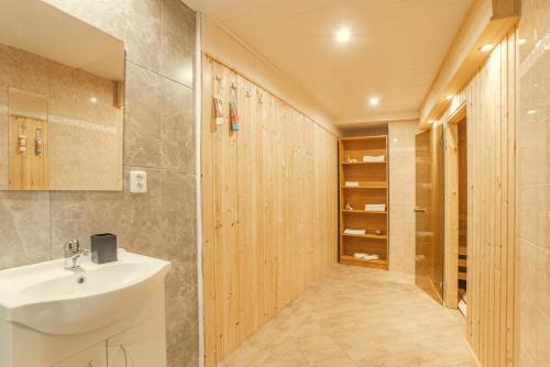 a bathroom with a white sink and a walk in closet at Wellness studio! Finnish sauna, Whirlpool, Gym & more! in Prague