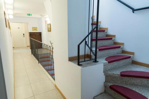 a staircase in a building with red cushions at Buon Hotel Bologna Centro - Affittacamere - Self Check-In in Bologna