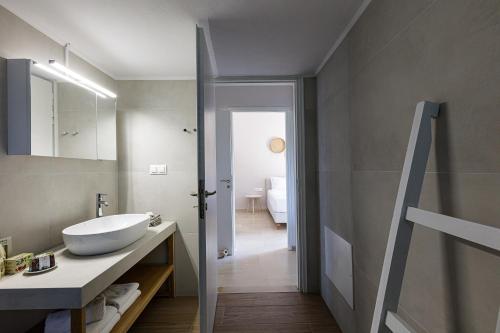 a bathroom with a sink and a mirror at Mithonies Villa, with Private Pool & BBQ, By ThinkVilla in Margarítai