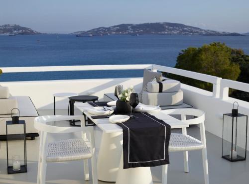 a white table with a wedding cake on a balcony at Nimbus Mykonos in Agios Stefanos