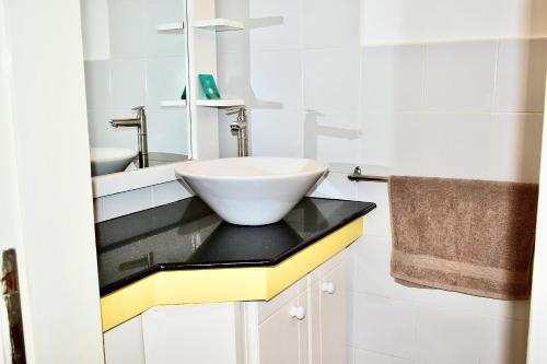 a bathroom with a sink and a bowl on a counter at VILLA DES ILES MONT CHOISY in Mont Choisy