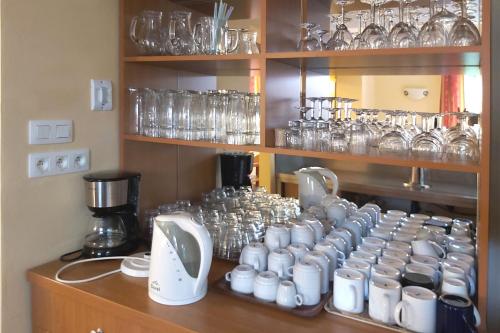 a bunch of glasses are lined up on a shelf at Chalupa Chiranka in Lipova Lazne