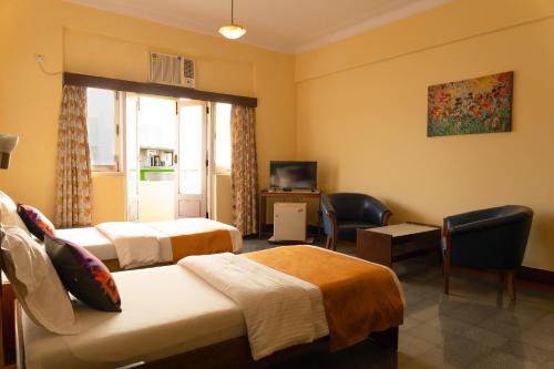 Ένα ή περισσότερα κρεβάτια σε δωμάτιο στο Sea Green South Hotel