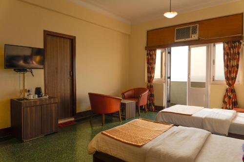 Ένα ή περισσότερα κρεβάτια σε δωμάτιο στο Sea Green South Hotel
