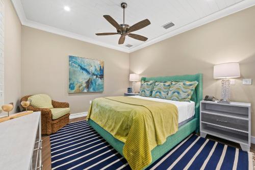 a bedroom with a bed and a ceiling fan at Anna Maria Beach Resort in Holmes Beach