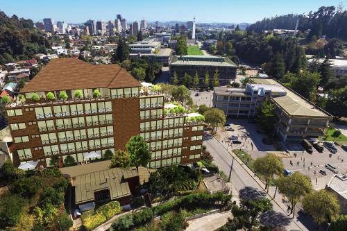 an aerial view of a building with a city in the background at Studio Victoria 400 in Concepción