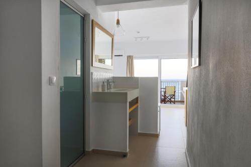 a kitchen with a sink and a view of the ocean at Sea Breeze Hotel in Hersonissos