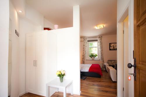 a small room with a white door and a bedroom at Apartments Top Center in Zagreb