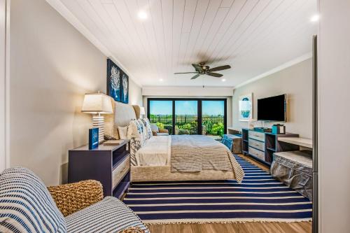 a bedroom with a bed and a tv at Anna Maria Beach Resort in Holmes Beach