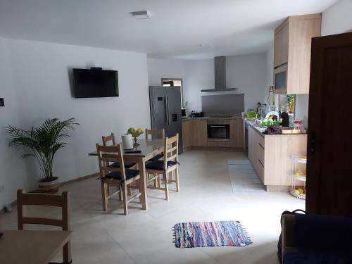 a kitchen and dining room with a table and chairs at Casa Novelhos in Penafiel