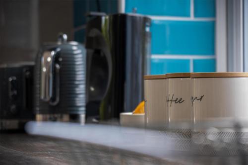 a coffee cup sitting on top of a counter at Haylands Hideaway - 1 Bedroom Apartment - Jameston in Manorbier