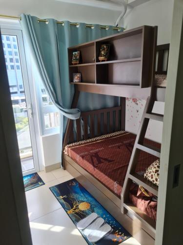 a small room with a bunk bed and a window at Cool at Wind Residences Tagaytay with FREE Use of Parking Space at Basement Building in Tagaytay