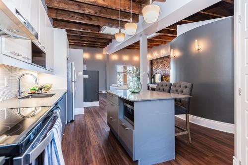 a kitchen with blue cabinets and a counter top at Family Friendly 3-bedroom beauty in Le Plateau by DenStays in Montréal
