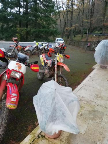 a group of motorcycles parked in a parking lot at Ostello La Miniera in Massa Marittima