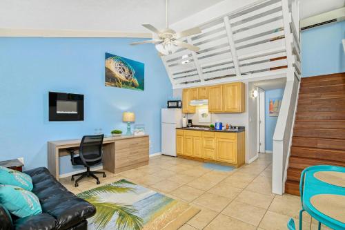 a living room with a couch and a desk at Latitude 26 Waterfront Resort and Marina in Fort Myers Beach