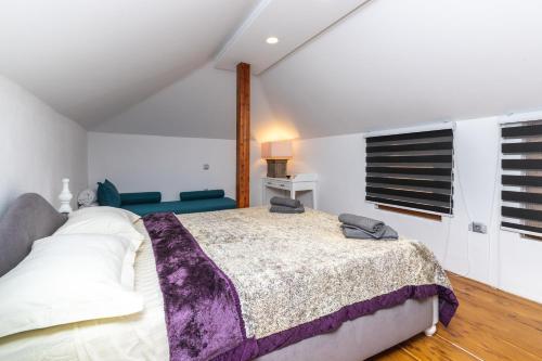 a bedroom with a large bed and a window at Nymphes House Pefkochori in Pefkohori