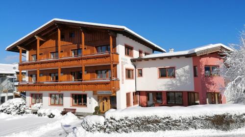a building with snow in front of it at Pension Alpina in Reith im Alpbachtal