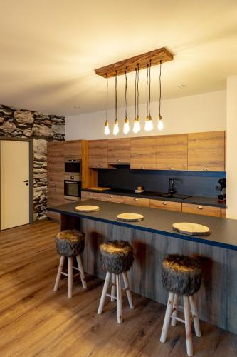 a kitchen with a large counter with stools at GUILLEMINS STATION FLATS in Liège
