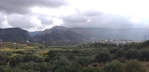 a town in the middle of a valley with mountains at Petrino in Sisi with private pool and garden in Sissi