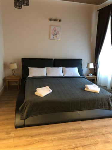 a bedroom with a bed with two towels on it at Casa Oliver in Braşov