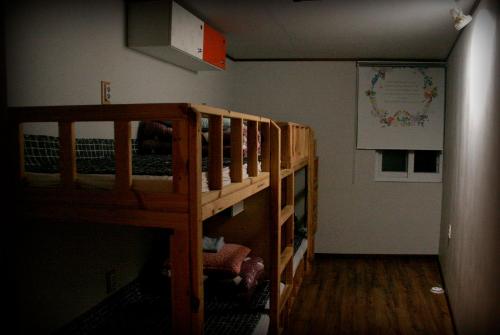 a bedroom with two bunk beds in a room at Gangneung Guesthouse Myu in Gangneung