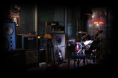 a dark room with a room with music equipment at Gangneung Guesthouse Myu in Gangneung