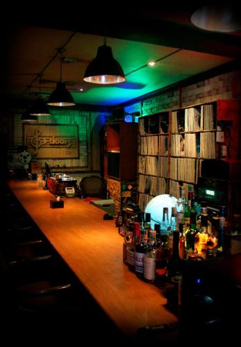 a bar in a room with a lot of alcohol at Gangneung Guesthouse Myu in Gangneung