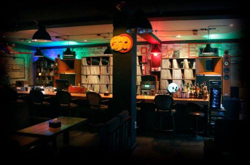 a restaurant with a bar with a pumpkin clock at Gangneung Guesthouse Myu in Gangneung