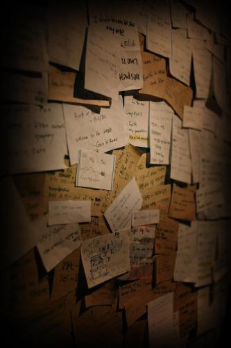 a wall filled with lots of pieces of paper at Gangneung Guesthouse Myu in Gangneung