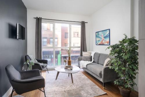 a living room with a couch and chairs and a table at Hotel-Apart Prince Arthur in Montréal