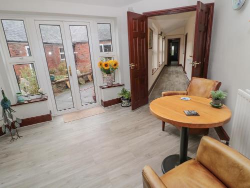 a living room with a table and chairs at Barnacre in Morpeth