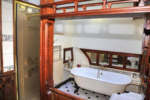 a bath tub in a bathroom with a wooden frame at Panorama Cottages in Llangollen