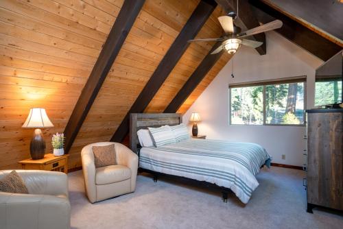a bedroom with a bed and a ceiling fan at North Shore - Cozy Cabin in Wood Vista