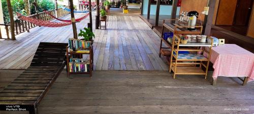 a table and chairs on a wooden deck at TA YAI HOMESTAY (ตา ยาย โฮมสเตย์) in Ko Kood