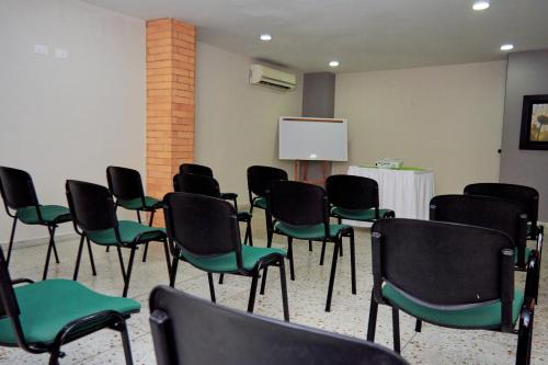 a conference room with chairs and a white board at Hotel Torre del Prado in Barranquilla