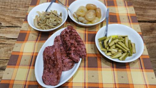 a table topped with plates of meat and bowls of food at B&B Il Pittore in Borgo San Lorenzo