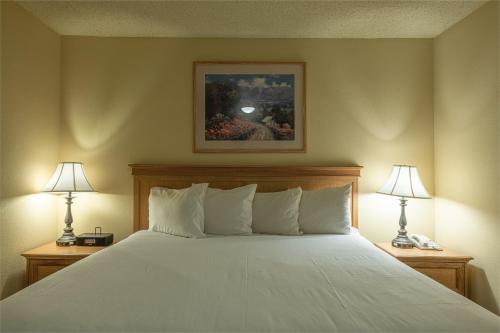 a bedroom with a large white bed with two lamps at Grand Lodge Condo in the Heart of Mt Crested Butte condo in Crested Butte