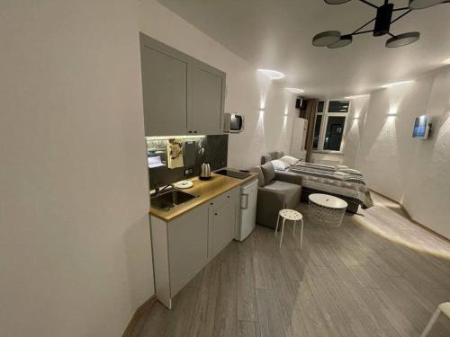 a kitchen with a sink and a bed in a room at Arcadia apartment & sea terrace in Odesa