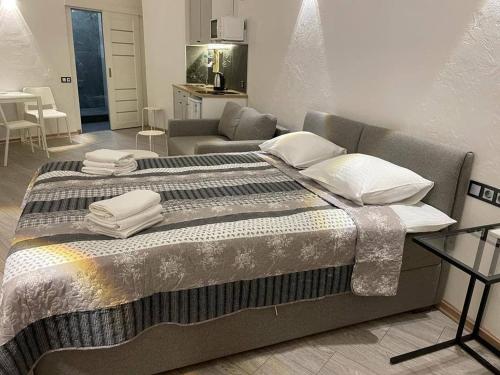 a large bed in a room with a couch at Arcadia apartment & sea terrace in Odesa