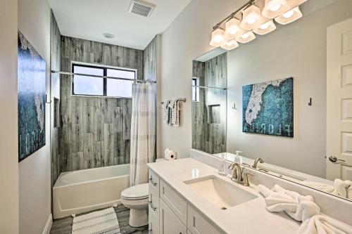 a bathroom with a sink and a tub and a toilet at Sun-Seekers Getaway Lavish Cape Coral Villa in Cape Coral
