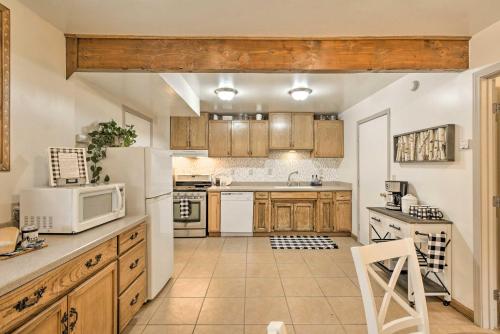 a kitchen with wooden cabinets and a white microwave at Family Home Near Kings and Sequoia National Parks! in Squaw Valley