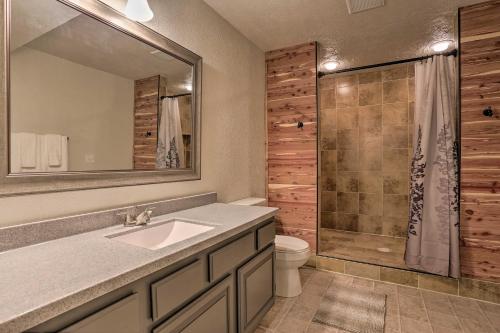 a bathroom with a sink and a toilet and a shower at 14 A Getaway Family House with Large Deck! in Sturgis