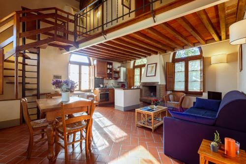 a living room with a blue couch and a table at Agriturismo I Bonsi in Reggello
