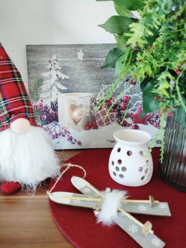 a christmas table with a santa claus ornament and cutlery at Apartman Glacier in Tatranska Strba