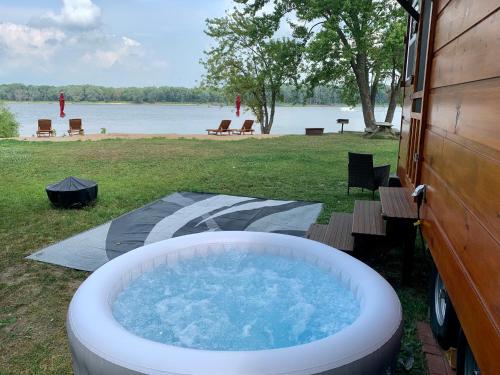 a large bath tub sitting in the grass next to a building at Shady Haven - Tiny Home 1 in Bellevue