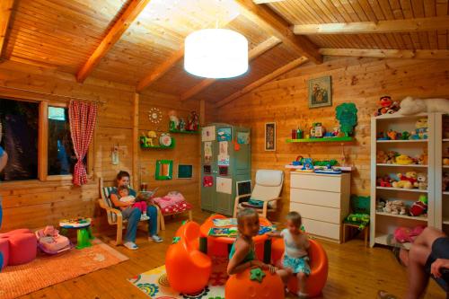 a group of children in a room with a woman at Hotel Rivijera in Petrovac na Moru
