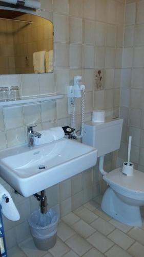 a bathroom with a white sink and a toilet at Gästehaus Maschler in Sankt Anton am Arlberg