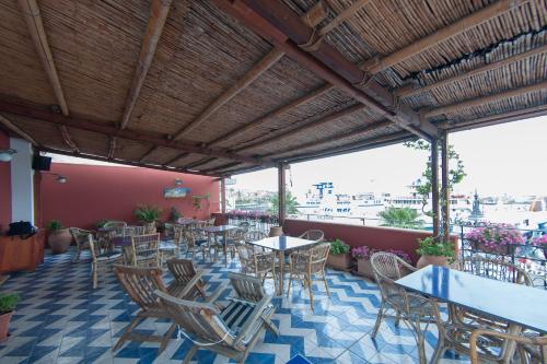 restauracja ze stołami i krzesłami na patio w obiekcie Petit Hotel w mieście Milazzo