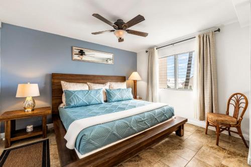 a bedroom with a bed and a ceiling fan at Kailua Village#307 in Kailua-Kona