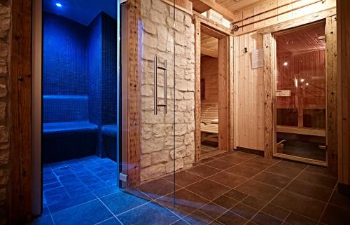 a walk in shower with a glass door in a bathroom at Residence Derby Club in Folgaria